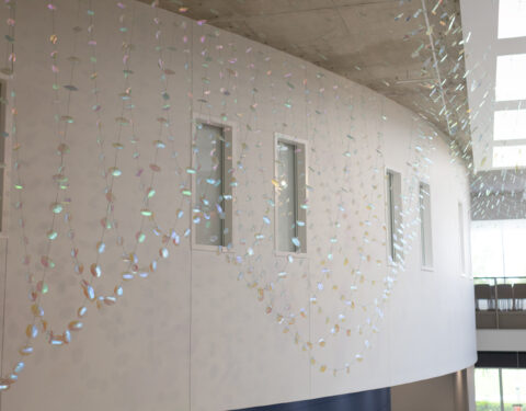 2,000 dichroic glass petals and leaves suspended in the a