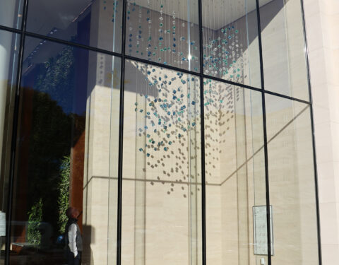 Closer view of the suspended sculpture from outside the window in the morning Closer view of the suspended sculpture from outside the window in the morning